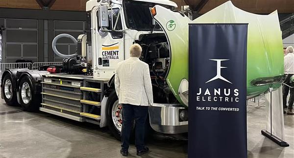 A man looks up at a Janus Electric EV truck at the Everything Electric roadshow.