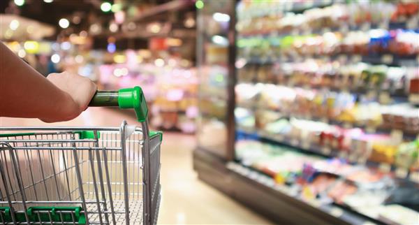 Woman pushing a supermarket trolley