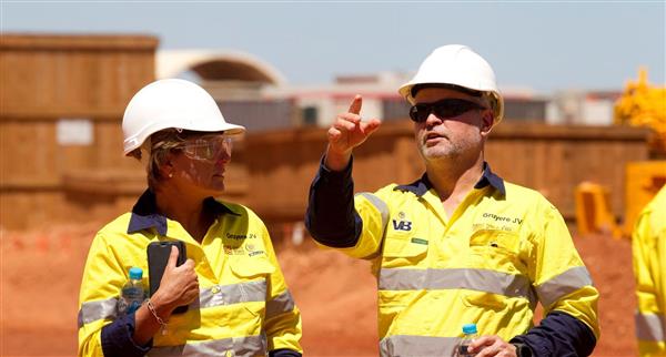 Two Grueye joint venture workers talk at the front of the gold mine.
