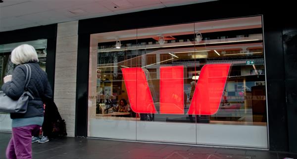 Aged woman walks in front of Westpac bank in Melbourne Australia