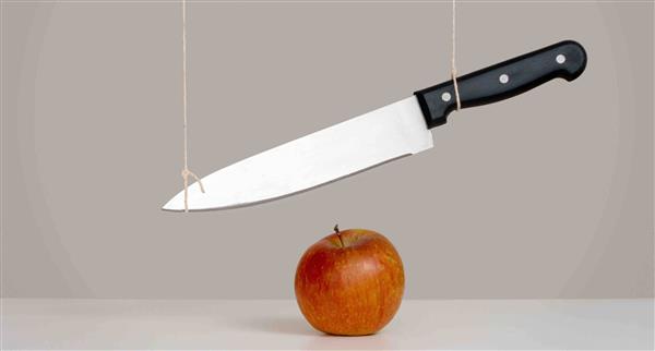 A sword dangles above your head in this case a crisp apple