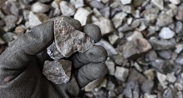 Hand holding polymetallic material