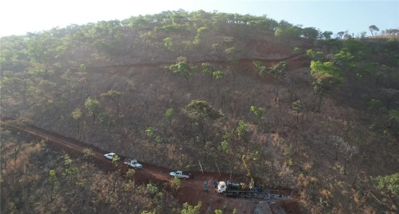 Rigs driving up a mountain road at the Step Aside lithium project.