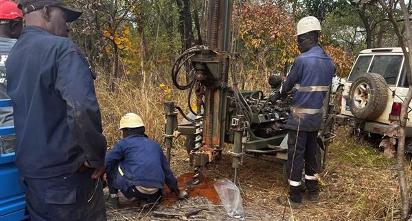 Haranga Resources workers check on an RC drilling rig at Ibel South.